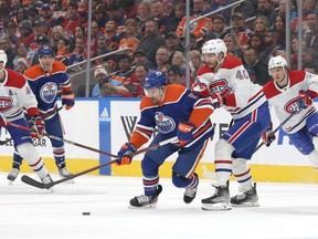Cody Ceci (#5) of the Oilers battles Joel Armia (#40) of the Canadiens in the first period on December 3, 2022 at Rogers Place in Edmonton.