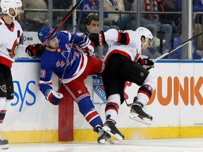 Senators defenceman Artem Zub lays the body on Rangers forward Chris Kreider in the first period of Friday's game in New York.