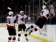 Brady Tkachuk of the Ottawa Senators celebrates his game-tying goal goal with teammates Jake Sanderson and Alex DeBrincat during the last minute of the third period against the New York Rangers at Madison Square Garden on Dec. 2, 2022 in New York City.