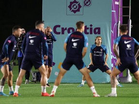 DOHA, QATAR - DECEMBER 15: Luka Modric of Croatia stretches  during the Croatia training session at Al Erssal Training Site on December 15, 2022 in Doha, Qatar.