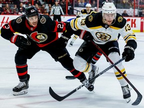 Ottawa Senators defenceman Travis Hamonic (23) battles with Boston Bruins centre Charlie Coyle (13) during second period NHL action at Canadian Tire Centre on Oct. 18, 2022. – The Senators face the Bruins Dec. 27 at 7 p.m. at the Canadian Tire Centre.