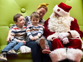 Kate Milicevic and her boys, four-year-old Luka (right) and five-year-old Oliver, visit with Santa at the Carlingwood Mall on Tuesday, Dec. 13, 2022.