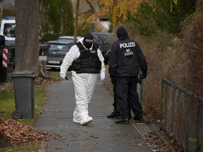 Policemen are seen in a street during a raid on December 7, 2022 in Berlin that is part of nationwide early morning raids against members of a far-right "terror group" suspected of planning an attack. - During the nationwide raids, police arrested 25 people suspected of belonging to a far-right "terror cell" plotting to overthrow the government and attack parliament.