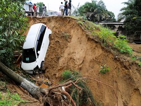 A car is seen stuck after heavy rains caused floods and landslides, on the outskirts of Kinshasa, Democratic Republic of Congo December 14,2022.
