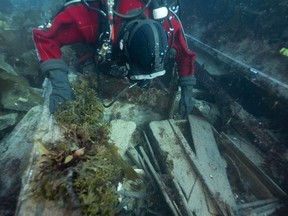 Parks Canada underwater archaeologist Jonathan Moore observes a washing basin and an officer's bedplace on the lower deck of the wreck of HMS Erebus during a dive in this September 2022 handout photo in the Northwest Passage.