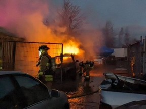 Ottawa Fire Services crews fight the fire in a commercial building on Leitrim Road on Saturday afternoon.