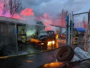 Ottawa Fire Services crews fight the fire in a commercial building on Leitrim Road on Saturday afternoon.