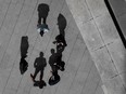 Office workers talk outside an office building in Bogota.