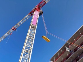 Ottawa Fire Services rope rescue experts lift a litter with a crane operator who suffered a medical emergency Friday morning.at a site on Central Park Drive off of Merivale Road.