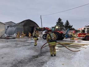 Ottawa Fire Services crew members work to extinguish a blaze in a shed on a property near Mitch Owens Road on Thursday afternoon.