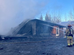 Ottawa Fire Services crews work to extinguish a workshop fire at a residence on David Manchester Road in Carp on Wednesday.