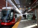 Commuters take the LRT in Ottawa on Friday. 