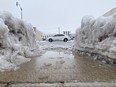 A vehicle travels east along Broad Street in the city of Hazleton Pa., as seen from a cutout in the snow bank near the Hayden Family Center for the Arts on Friday, Dec.16, 2022. The passing storm left about 5 inches of snow.