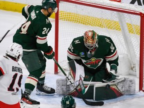 Minnesota Wild goalie Filip Gustavsson (32) blocks a shot by Ottawa Senators right wing Drake Batherson (19) as Wild defenceman Matt Dumba (24) looks on during the third period of an NHL hockey game Sunday, Dec. 18, 2022, in St. Paul, Minn.