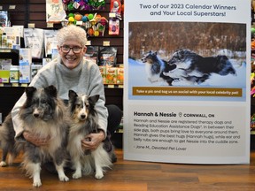 Jane McLaren with Hannah (left) and Nessi (right) at the Eastcourt Mall Pet Valu, with a large display showcasing their winning photo on Monday December 12, 2022 in Cornwall, Ont.