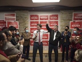 Prime Minster Justin Trudeau delivers remarks next to Charles Sousa at his campaign office, during a byelection campaign stop in Mississauga, Ont., on, Thursday, December 1, 2022.