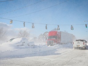 Vehicles are left stranded on the road following a winter storm that hit the Buffalo region on Main St. in Amherst, New York, U.S., Dec. 25, 2022.