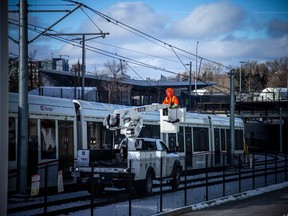 LRT issues continued Sunday, Jan. 8, 2023, with multiple trains stuck on the tracks between Lees station and Tremblay station. Crews were working above a train on the east side of Lees station Sunday.