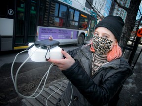 In this file photo from 2021, Autumn Jordan shows how she takes readings with air quality monitoring equipment in Ottawa.