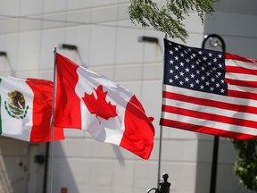 FILE PHOTO: Flags of the U.S., Canada and Mexico fly next to each other in Detroit, Michigan