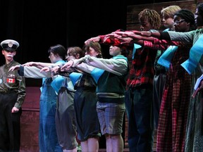 Colonel Burnett played by Zack Boniface (FL), and students played by Jaden Croucher, Makylla Sauve, Kealey Lahey, Ara Daigle, Benjamin Shimwa, Simon Boniface, Manuella Lado, and Anne-Victoria Lado at St Paul High School’s Cappies production of the Schoolhouse on December 9, 2022, in Ottawa.