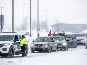 Ottawa police were redirecting a few vehicles with flags and decals on them on the Sir John A. Macdonald Parkway Sunday, Jan. 29, 2023. ASHLEY FRASER/Postmedia