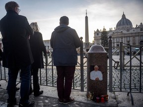 A picture of Pope Benedict XVI is seen at St. Peter's Square after the announcement of the death of the former pope on Saturday, Dec. 31, 2022, in Vatican City, Vatican.