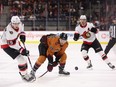 Drake Batherson (left) and Thomas Chabot of the Ottawa Senators and Arizona Coyotes' Christian Fischer at Mullett Arena on January 12, 2023 in Tempe, Arizona.