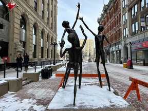Some damaged and hanging pieces of the "Joy" statue at the Sparks Street Mall were removed and barricades were set up to keep pedestrians away after vandals allegedly damaged the statue earlier this week. Pictured Wednesday, Jan. 11, 2023.