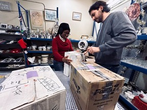 Staff members Abigail Chukwuma and Soroush Jafari are seen working at the Matthew House Ottawa Furniture Bank.