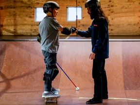 10-year-old Ollie Acosta-Pickering, who is blind after cancer treatment, is relearning how to skateboard with the help of Jordan Wells at The Yard. January 20, 2023.