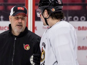 Ottawa Senators assistant coach Bob Jones (L) talks with right wing Drake Batherson during team practice at the Canadian Tire Centre on January 24,2023.