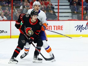 Ottawa Senators centre Ridly Greig (17) and New York Islanders defenceman Samuel Bolduc (4) during first period NHL action at the Canadian Tire Centre on Wednesday, Jan. 25, 2023.
