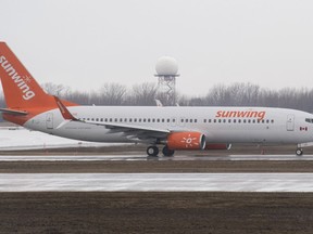 A Sunwing Airlines jet prepares to takeoff at Trudeau International Airport in Montreal on Friday, March 20, 2020. Some Sunwing travellers from Saskatchewan say the airline is leaving them at airports in other provinces, while another says her flight from Mexico that made it to Regina had dozens of empty seats. THE&ampnbsp;CANADIAN PRESS/Graham Hughes