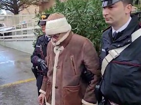 This handout video grab taken and released by the Italian Carabinieri Press Office on January 16, 2023 shows the arrest by Carabinieri of the Italy's top wanted mafia boss, Matteo Messina Denaro in Palermo, in his native Sicily after 30 years on the run.