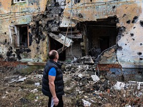A resident of Izium, in eastern Ukraine, checks out destruction around his shelter on Jan. 2, 2023.