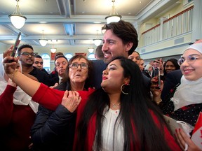 Prime Minister Justin Trudeau poses for photos with new Canadians at a citizenship ceremony at Acadia University in Wolfville, N.S., on March 3, 2020.