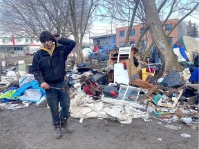 Former Integrated Care Hub encampment camper Nathan Rosevere cleans an area of  the encampment on Montreal Street in Kingston on Friday January 6, 2023. On Friday remaining residents of the encampment were advised by Wednesday January 11th the encampment will be closed and any items remaining will be removed.