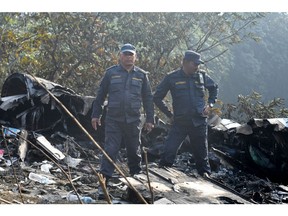 Rescuers inspect the wreckage at the site of a plane crash in Pokhara on January 15, 2023.