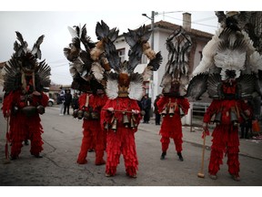 People wearing masks made of feathers participate in a winter festival in the village of Kosharevo, Bulgaria January 14, 2023.