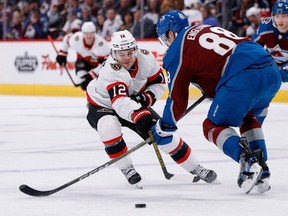 Ottawa Senators right wing Alex DeBrincat and Colorado Avalanche defenceman Andreas Englund battle for the puck in the third period at Ball Arena.