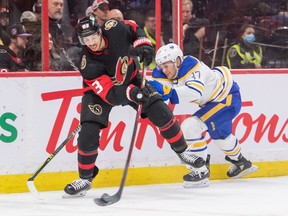 Ottawa Senators defenseman Travis Hamonic (23) clears the puck away from Buffalo Sabres center Casey Mittetstadt (37) in the second period at the Canadian Tire Centre.