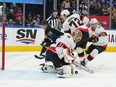 Senators goalie Anton Forsberg makes a save while teammate Thomas Chabot (72) holds off Maple Leafs winger Mitch Marner in the first period of Friday's game in Toronto.
