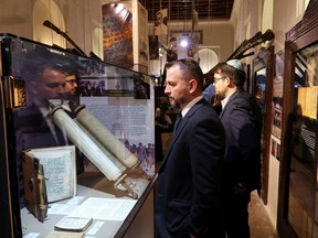 Visitors attend an event commemorating the Holocaust, in which a 16th century Torah scroll that survived the Holocaust was officially unveiled, at Crossroad of Civilizations Museum, in Dubai, United Arab Emirates, Jan. 28, 2023.