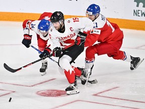 Shane Wright of Team Canada skates the puck past Czechia players Stanislav Svozil and Adam Mechura in the gold medal round of the 2023 IIHF World Junior Championship in Halifax on January 5, 2023.