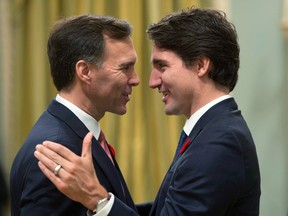 Prime Minister Justin Trudeau, right, congratulates Bill Morneau at Rideau Hall  in 2015 as the latter is sworn in as finance minister.