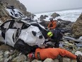 FILE - In this photo provided by the San Mateo County Sheriff's Office, emergency personnel respond to a vehicle over the side of Highway 1 on Jan. 1, 2023, in San Mateo County, Calif. The driver of the car that plunged 250 feet off a cliff in Northern California, injuring his two young children and his wife, has been released from the hospital and jailed on suspicion of attempted murder and child abuse. The San Mateo County District Attorney's Office announced Friday, Jan. 27, 2023, that Dharmesh Patel is being held without bail.