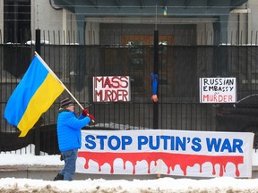 Protesters march outside the grounds of the Russian Embassy in Ottawa on Tuesday.