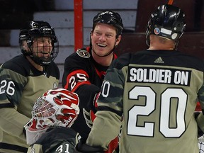 Former Ottawa Senator Chris Neil fools with Canadian Forces vet Brent Watters (20) and James McPhee (26) as the Ottawa Senators Alumni hosted Soldier On hockey camp in support of ill and injured veterans at Canadian Tire Centre.
