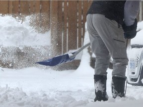 A person shovels snow in Ottawa.
